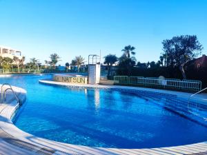 a large swimming pool with blue water at Estudio naturista 1 in Vera