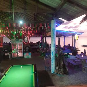 a pool table in a bar next to the ocean at Two Rocks Bungalows in Baan Tai