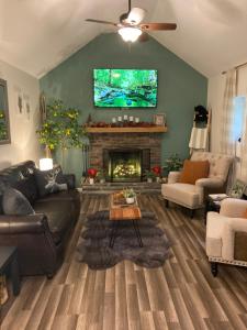 a living room with a couch and a fireplace at Cute private Wooded Cabin near the big lake in Tafton