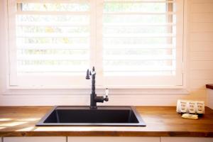 a sink in a kitchen with a window at Duck Walk Cottage - Boutique Studio Retreat in Burradoo