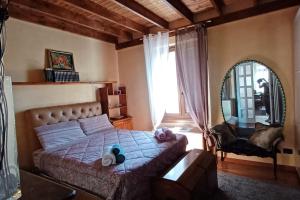 a bedroom with a bed and a chair and a window at GOLD HOUSE appartamento stazione centrale in Milan