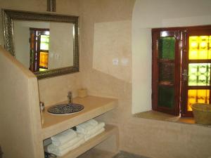 a bathroom with a sink and a mirror at Riad Souika in Rabat