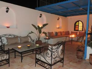 a living room with a couch and a table at Riad Dar Souika in Rabat
