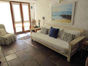 a living room with a couch with pillows on it at Resolana in Punta del Este