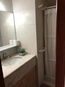 a bathroom with a sink and a shower at Resolana in Punta del Este