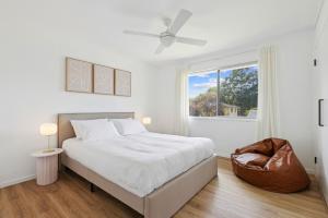 a white bedroom with a bed and a window at Lovely 3-Bed Family Home with Spacious Backyard in Oxford Park