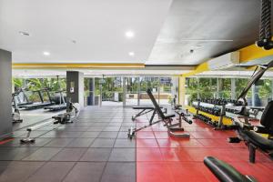 a gym with a lot of treadmills and machines at 3-Bed Luxurious Retreat by Brisbane River & CBD in Brisbane