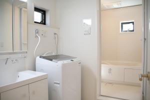 大阪市にあるCasa Stella 1 Aquarius by Liaisonの白いバスルーム(シンク、洗濯機付)