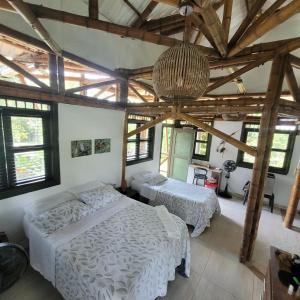 a bedroom with two beds and a chandelier at Carayurú in Mitú