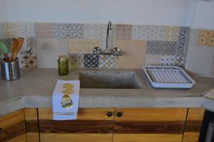a kitchen counter with a sink and a book on it at Andean Lodge in La Paz in La Paz