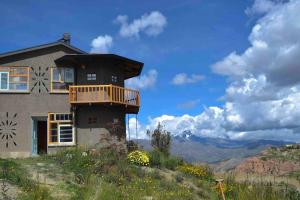 a house on top of a hill with a balcony at Andean Lodge in La Paz in La Paz