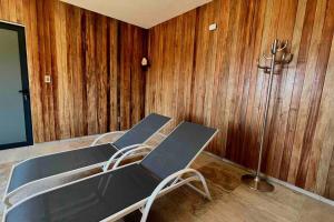 two chairs in a room with wooden walls at Andean Lodge in La Paz in La Paz