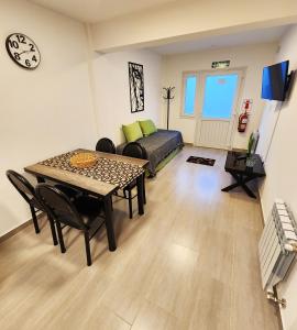 a living room with a table and a bed at COMARCA SUR Apartamentos in Ushuaia