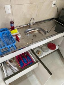 a small kitchen with a sink and some utensils at Loft BR 282 in Lages