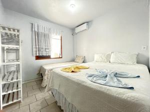 Ένα ή περισσότερα κρεβάτια σε δωμάτιο στο Casa da Vovó Silvina - Pertinho do Beto Carrero +22 φωτογραφίες
