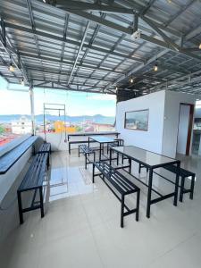 a group of tables and benches in a building at Maluku Residence Syariah in Ambon