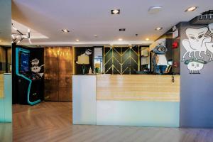 a restaurant with a counter with skulls on the wall at Havitat Boutique Hotel in Manila