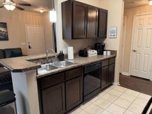 a kitchen with a sink and a counter top at Magnolia Serenity: 2BD/1BA w/ Gym, Pool, BBQ Grill in Tupelo