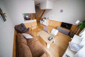a living room with a couch and a table at Learch Asahikawa in Asahikawa
