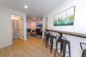 a kitchen and living room with a bar and stools at Quaint 1 BD 1 BTH Guest Home Minutes from Gonzaga in Spokane