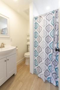 a bathroom with a toilet and a shower curtain at Quaint 1 BD 1 BTH Guest Home Minutes from Gonzaga in Spokane