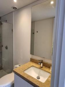 uma casa de banho com um lavatório, um WC e um espelho. em Loft en Centro Internacional con Vista Increíble em Bogotá