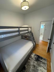 a bedroom with two bunk beds and a rug at Hojo House Winnipeg in Winnipeg
