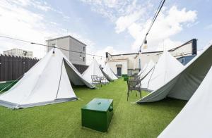a group of tents sitting on the grass at H-Evian Hotel in Gwangju