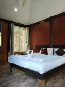 a bedroom with a large bed with a swan on it at Sahyadri Pride in Wai