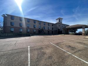 an empty parking lot in front of a building at The GuestHouse at Jackson in Jackson