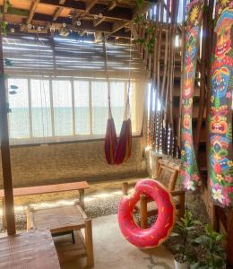 a room with a red donut hanging from the ceiling at Kubo house by the water in ELYU, Ba-ey Ad Shanom in San Fernando