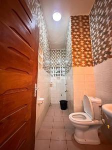 a bathroom with a toilet and a sink at Quick Apartments in Cotonou