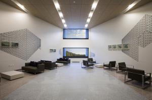 a waiting room with couches and chairs and a window at Hanwha Resort Yongin Besancon in Yongin