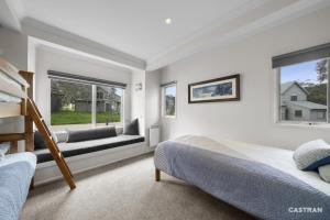 a bedroom with two beds and a window at Mayfair in Dinner Plain