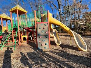 a playground with a slide in a park at Tiny Home, Near Downtown Durham, Duke & 9th Street! in Durham