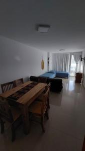 a living room with a table and a couch at Amanecer del Golfo in Puerto Madryn