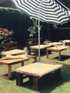a picnic table with an umbrella on the grass at Casa Pato in Mariano J. Haedo