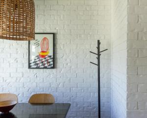 a room with a white brick wall with a cactus at Bay Properties Beach Street in Yamba