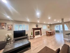 a living room with a television and a fireplace at 11640 Gothic Avenue in Los Angeles