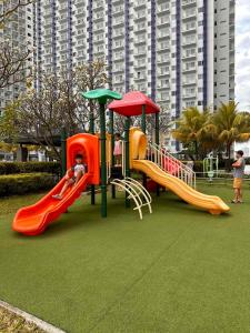 a playground with two slides and a slideintend at Makati SM Jazz Residence Staycation Condo with balcony in Manila +12 photos