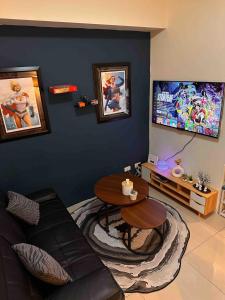 a living room with a table and a tv at Makati SM Jazz Residence Staycation Condo with balcony in Manila