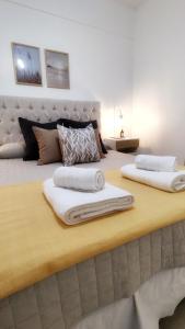 a large bed with two pillows on top of it at Ainhoa Beach MDP - A Pasos del Mar in Mar del Plata