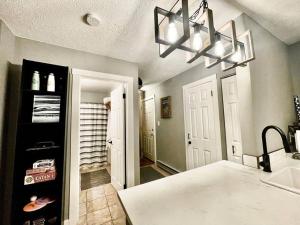 a kitchen with a chandelier and a hallway with a closet at Mountain Edge in Kimberley