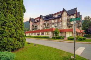 a large building with a street sign in front of it at Penthouse Lake Home - 3BR w/Amazing View & Deck! in Harrison Hot Springs