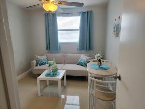 a living room with a couch and a table at C & Y Guesthouse in Tampa