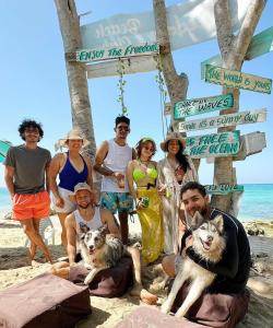 a group of people posing for a picture on the beach at Freedom Beach Club in Barú
