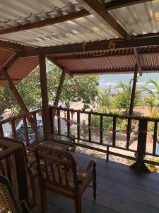 a porch with a bench and a view of the beach at Cabaña Roman in Cartagena de Indias