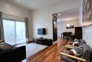a living room with a couch and a dining room at Townhouse 3 in Broken Hill