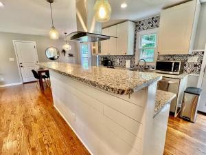 a kitchen with a large counter top in a room at Newly Renovated- King Suite, near WakeMed & Food in Raleigh
