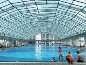um grupo de pessoas numa grande piscina em Homestay Vinhome Ocean Park R103 em Gia Lâm Pho